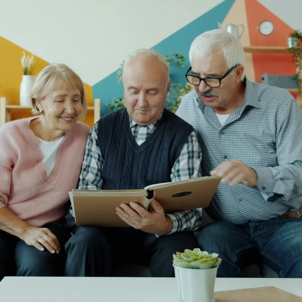Family members reviewing care home options together in a comfortable living room